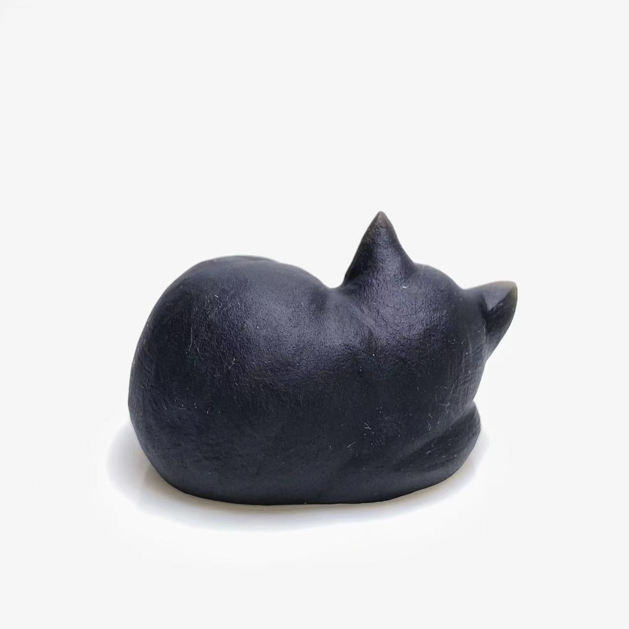 Black obsidian sleeping cat carving