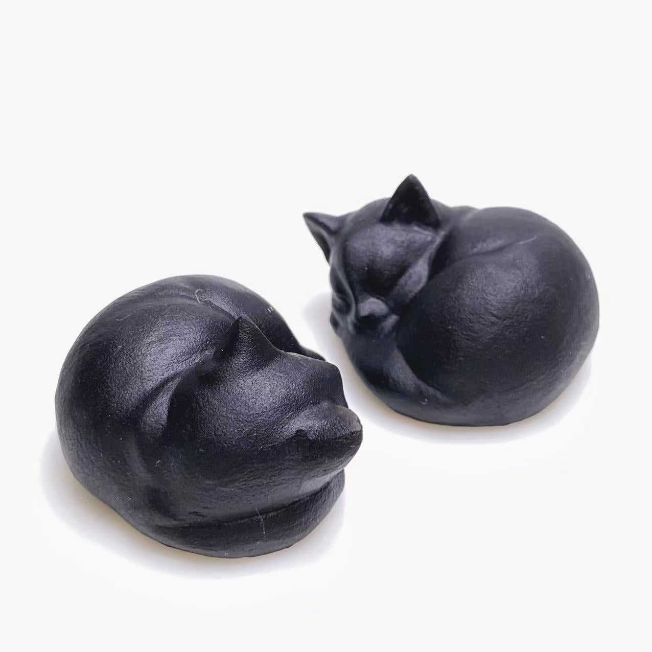Black obsidian sleeping cat carving