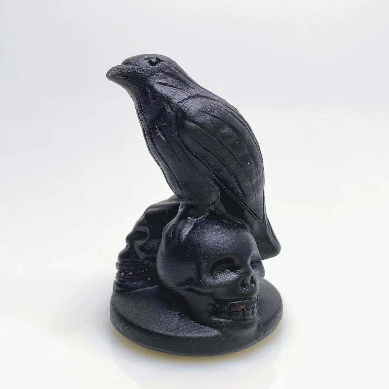Black obsidian raven on skulls carving