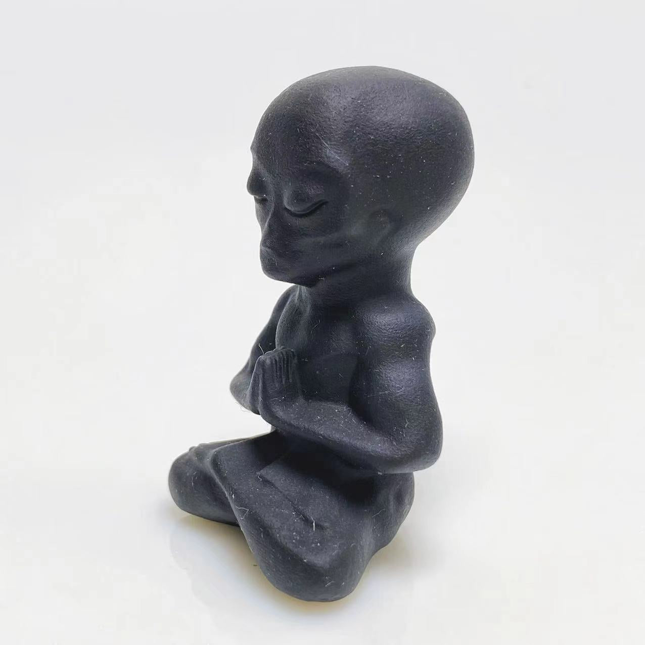 Black obsidian yoga alien carving