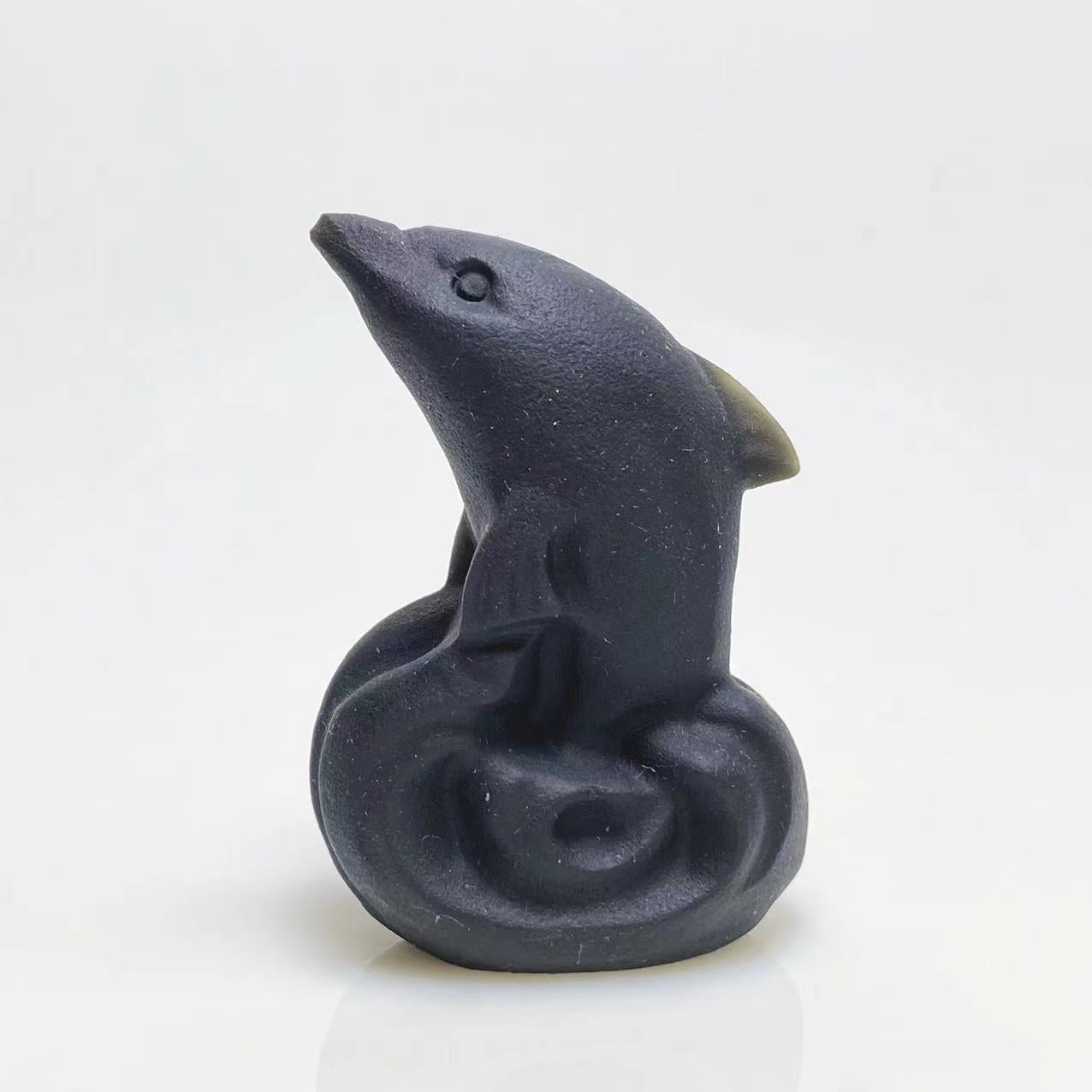 Black obsidian dolphin carving