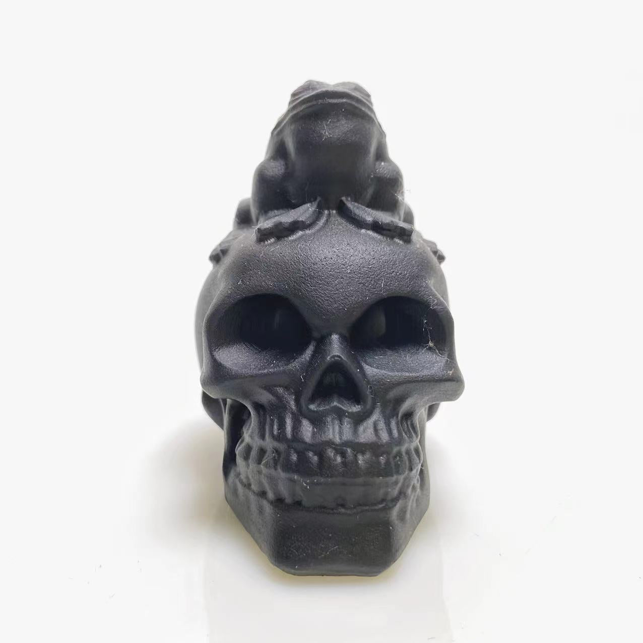 Black obsidian frog on skull carving