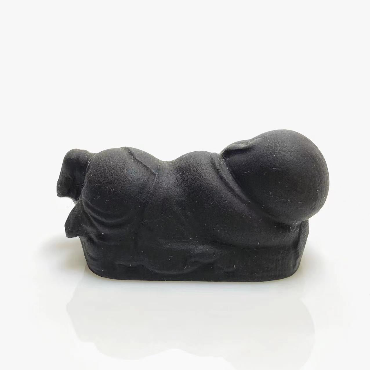 Black obsidian sleeping buddha carving