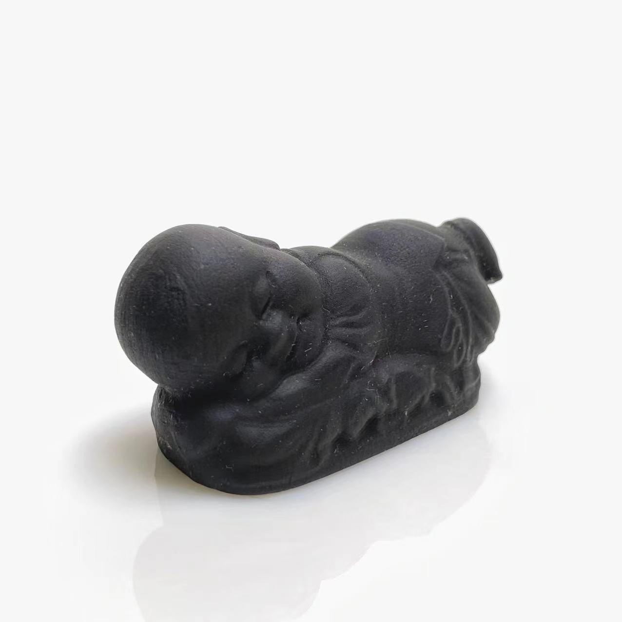 Black obsidian sleeping buddha carving