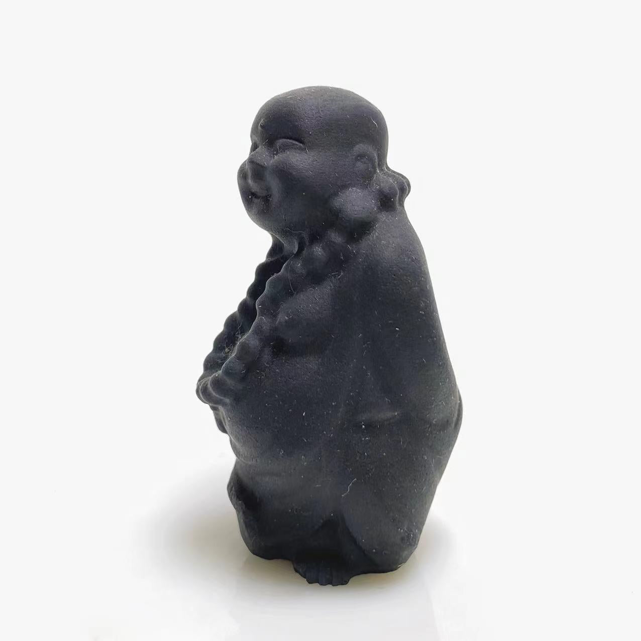 Black obsidian walking buddha carving