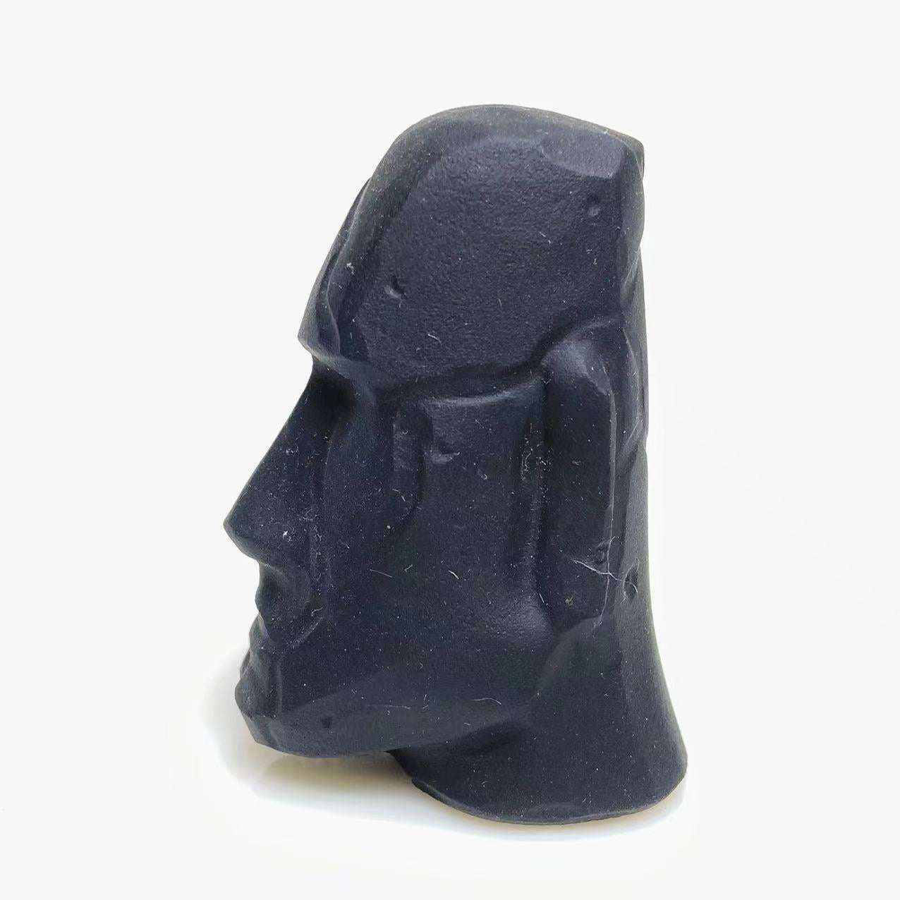 Black obsidian stone face carving