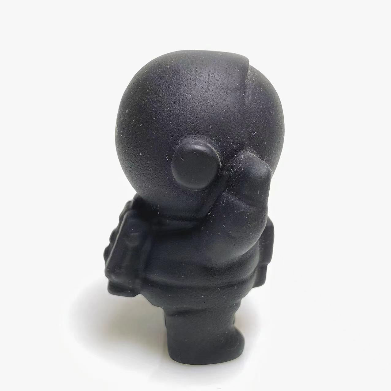 Black obsidian spaceman carving