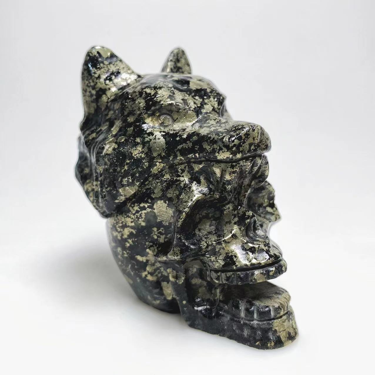 Pyrite skull with wolf head carving