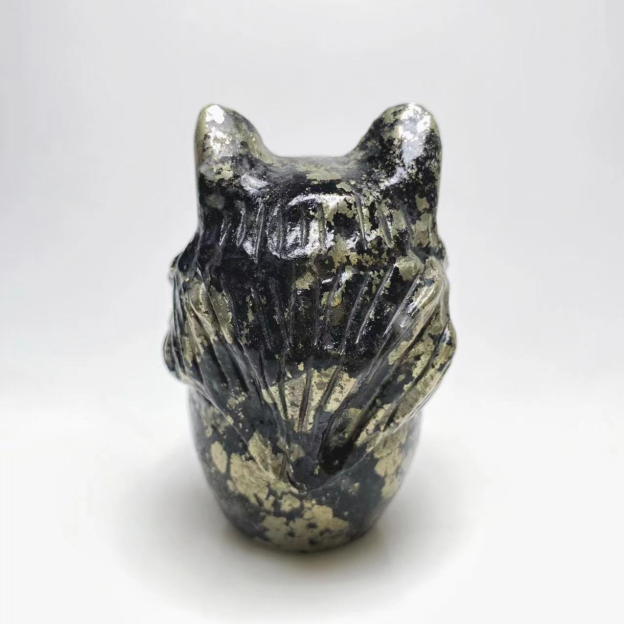 Pyrite skull with wolf head carving