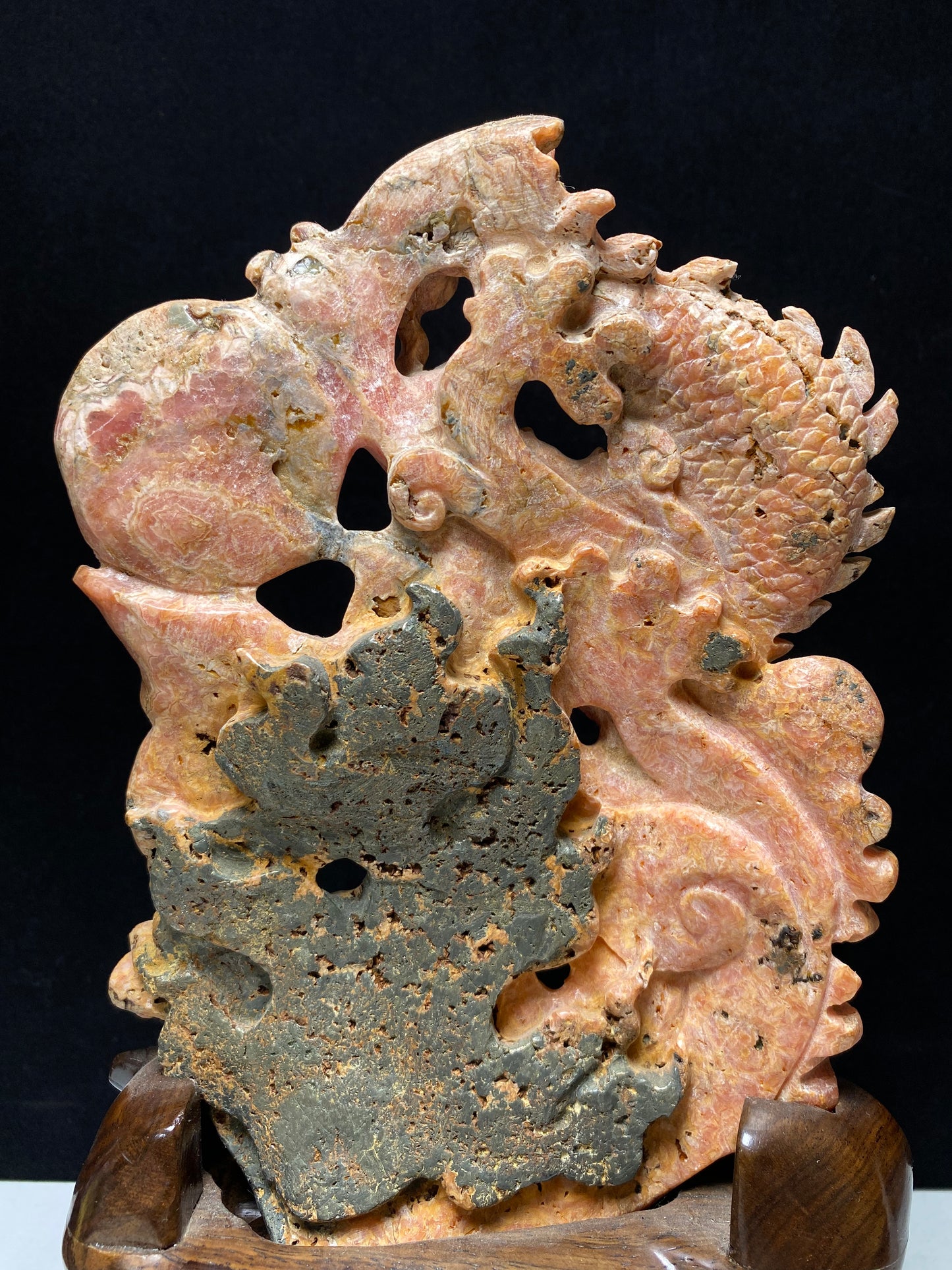 Rhodochrosite Chinese dragon with sphere carving and wooden stand