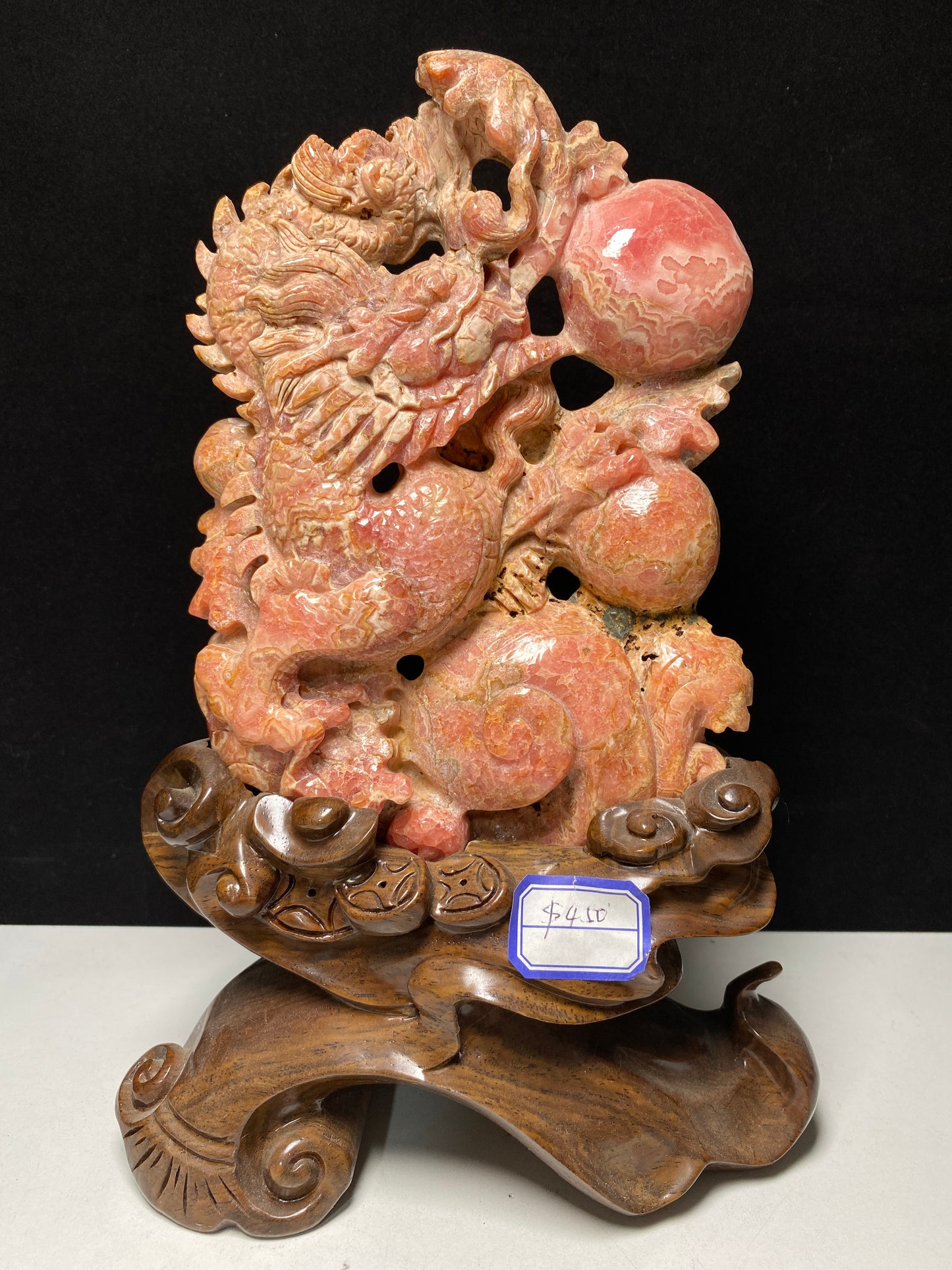 Rhodochrosite Chinese dragon with sphere carving and wooden stand