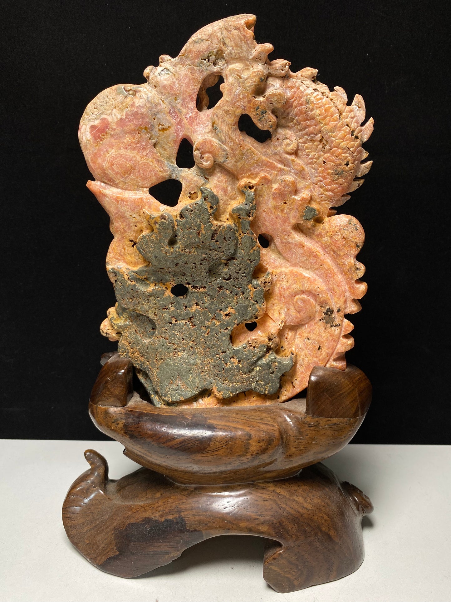 Rhodochrosite Chinese dragon with sphere carving and wooden stand
