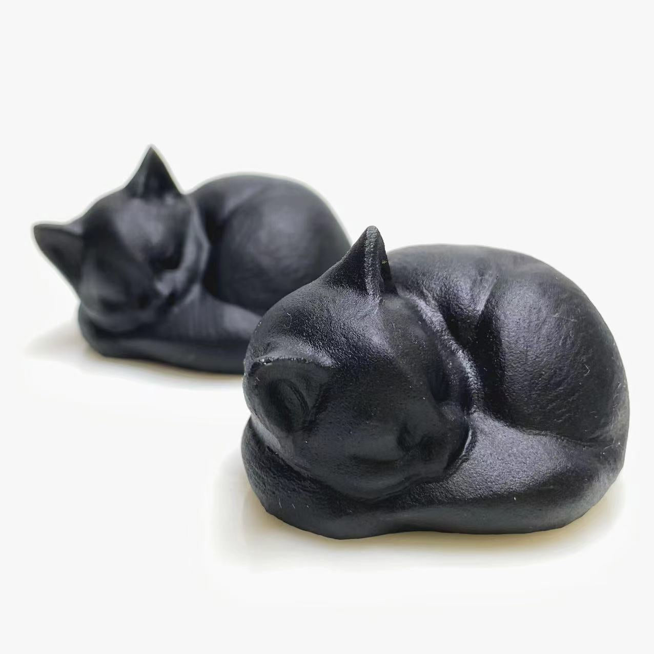 Black obsidian sleeping cat carving