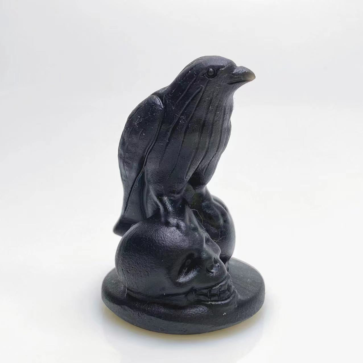 Black obsidian raven on skulls carving