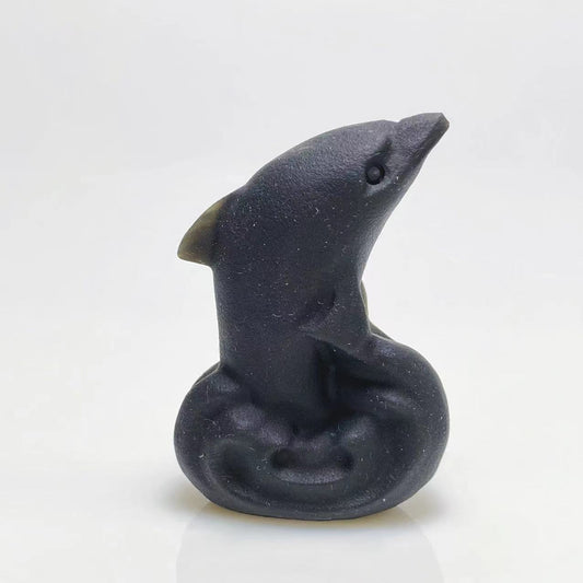 Black obsidian dolphin carving