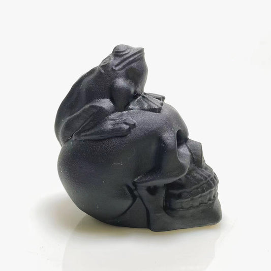 Black obsidian frog on skull carving