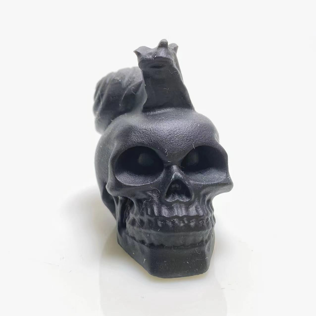 Black obsidian snail on skull carving