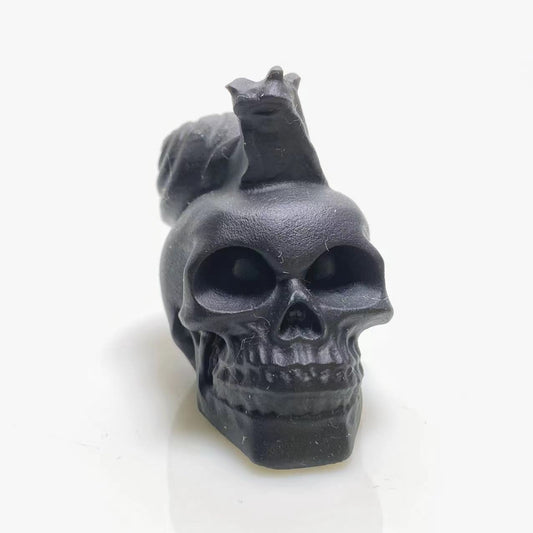 Black obsidian snail on skull carving