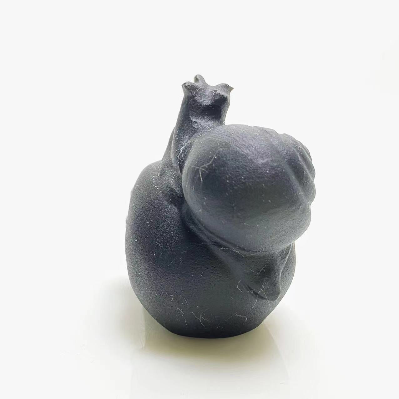 Black obsidian snail on skull carving