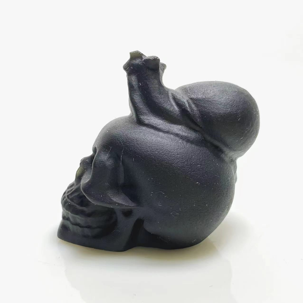 Black obsidian snail on skull carving