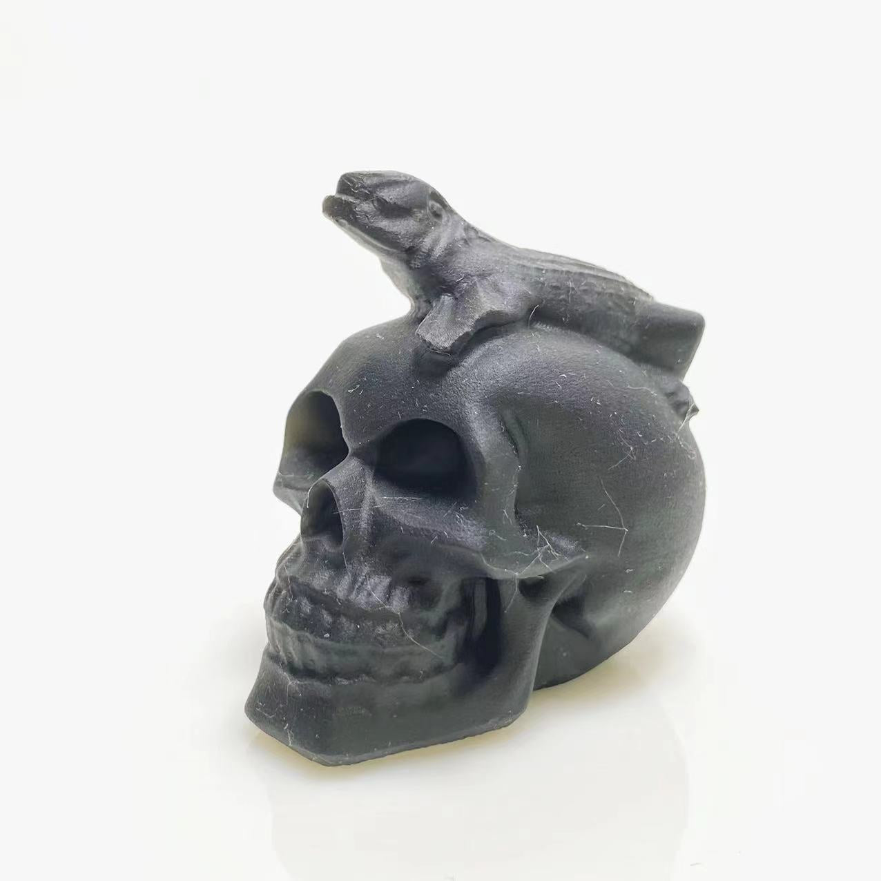 Black obsidian lizard on skull carving