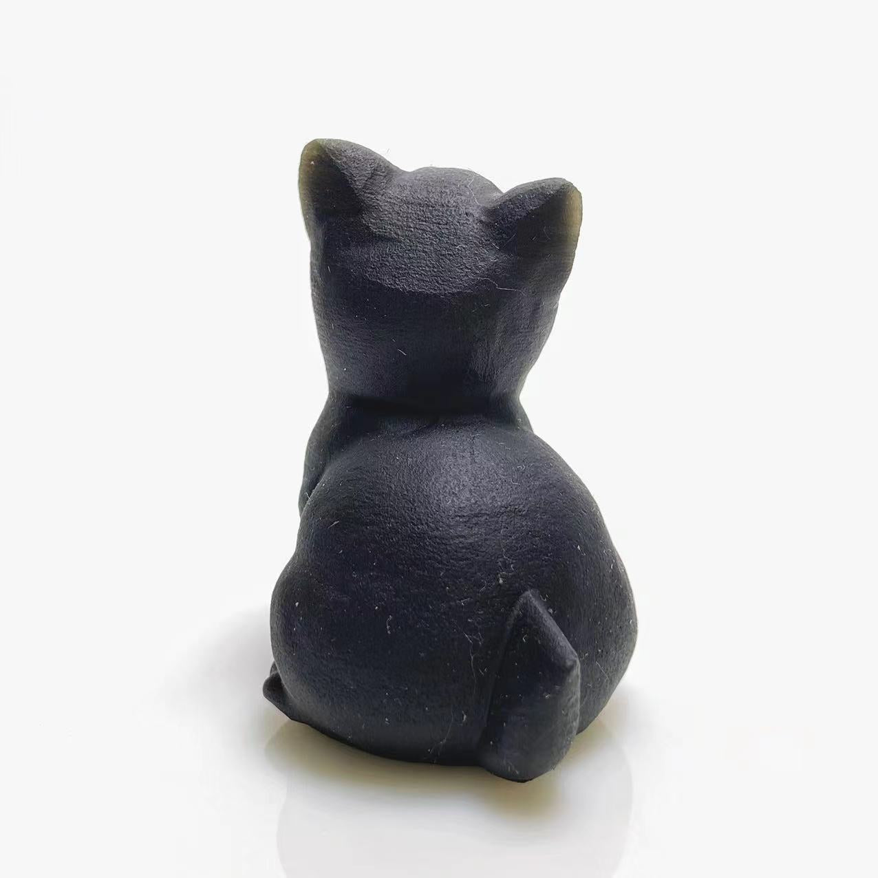 Black obsidian screaming cat carving