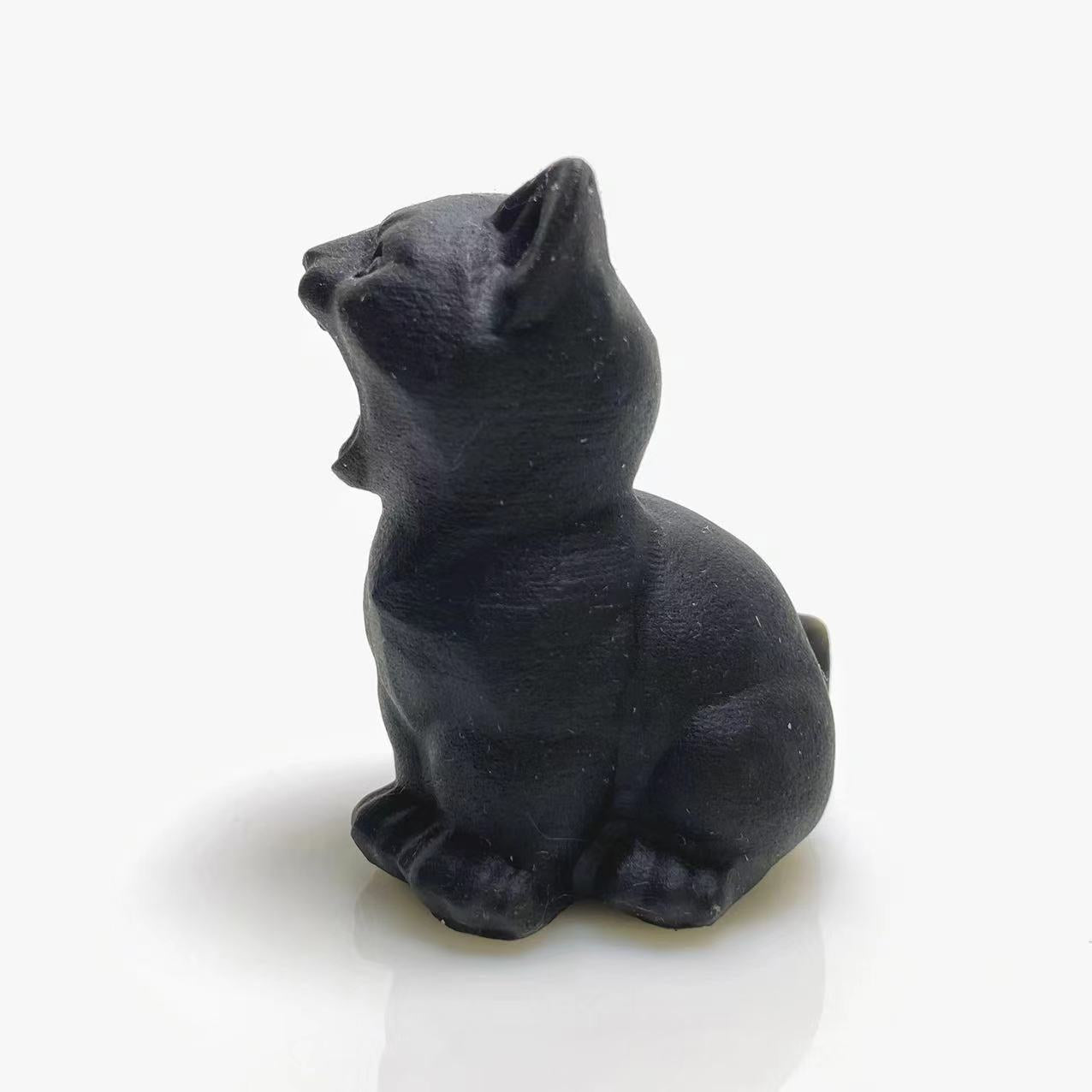 Black obsidian screaming cat carving